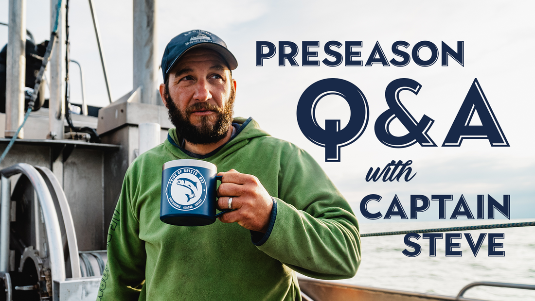 Steve in a green sweatshirt and blue baseball cap standing on a boat in Bristol Bay Alaska holding a metal coffee mug with a Pride of Bristol Bay sticker.