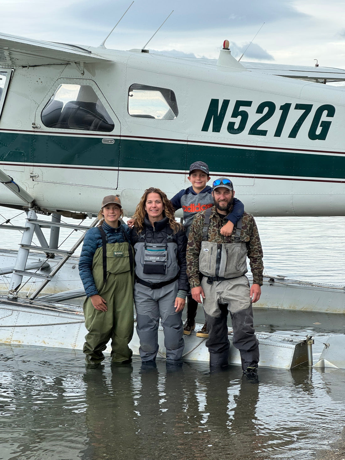 The Kurian family in AK in front of a small plane